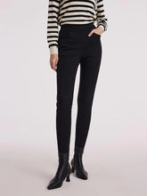 a woman in black cigarette pants